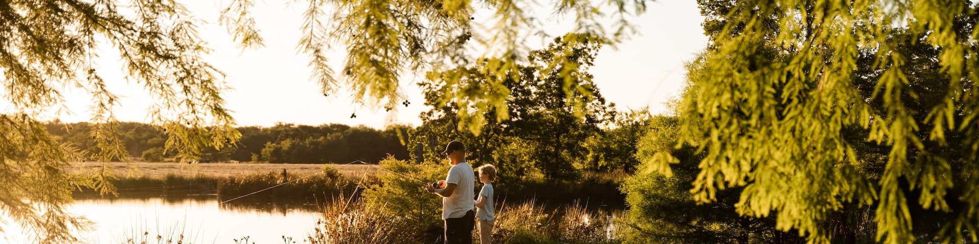 Father And Son Fish Together In Rural Oklahoma