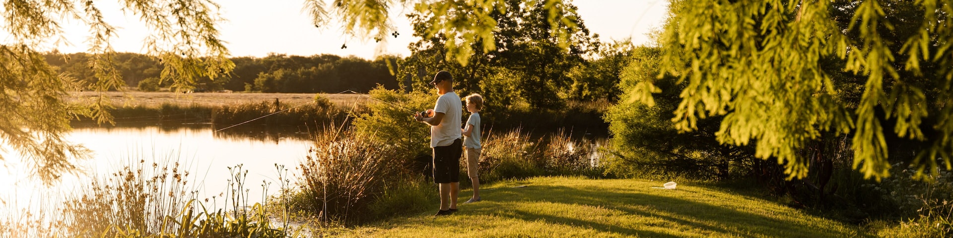 Father And Son Fish Together In Rural Oklahoma