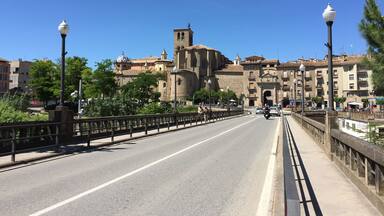 A bridge with a historic building in the background.