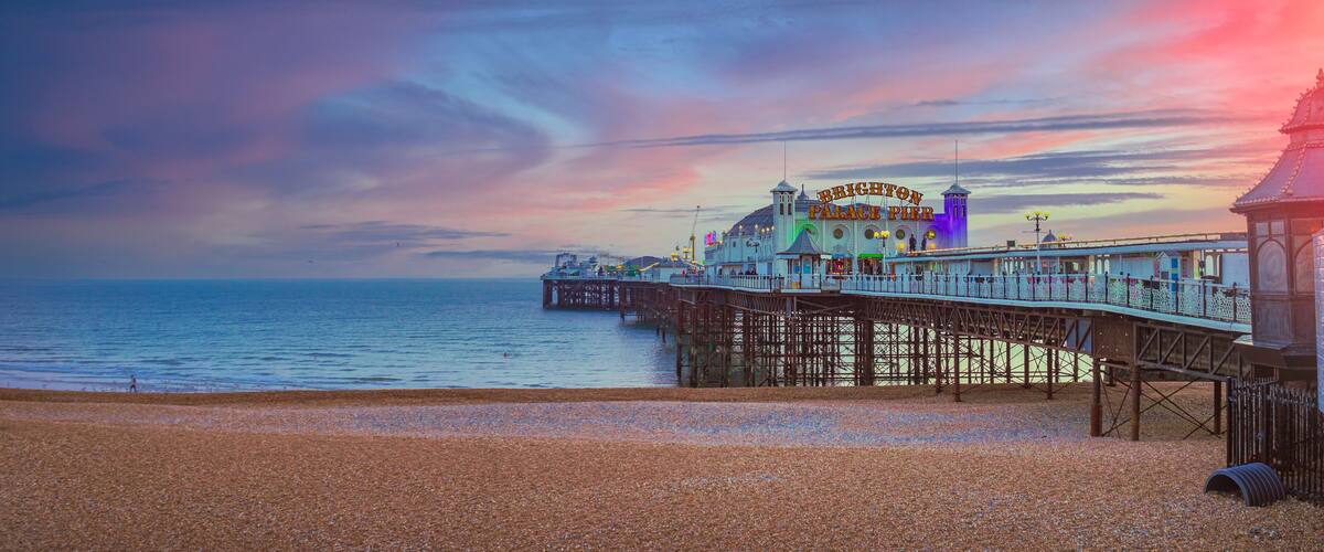 Brighton Palace Pier with a pebbled beach and the sea in the background.