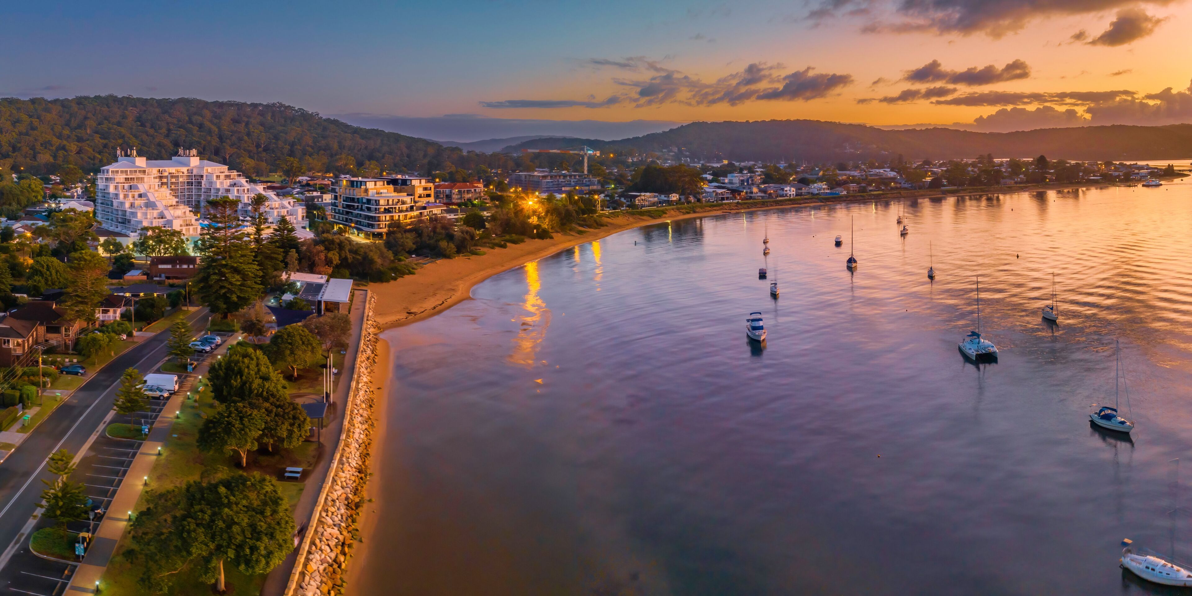 Early morning aerial views over the water with buildings and boats