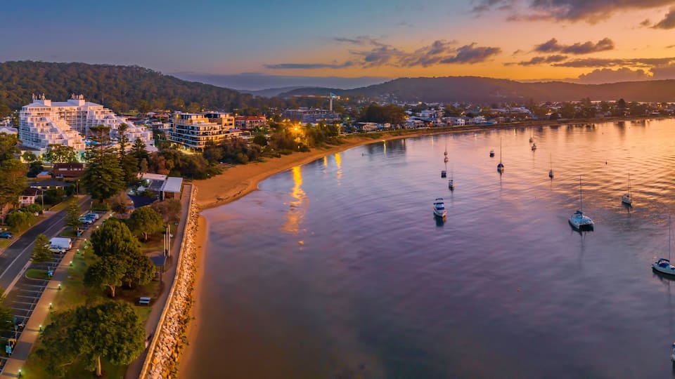 Early morning aerial views over the water with buildings and boats