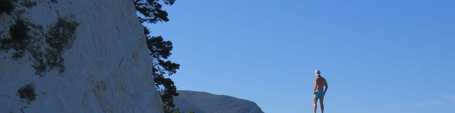 Beautiful pebble beach with white-faced rock cliffs.