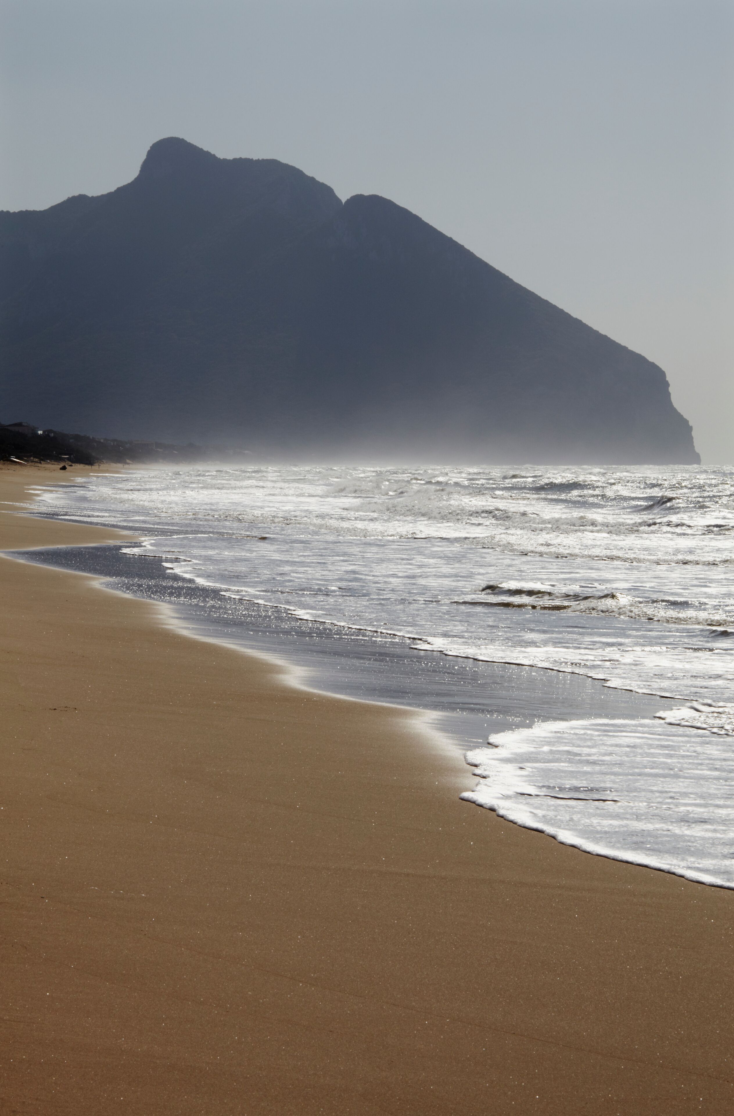 The silhouetted outline of Mount Circeo, seen from Torre Paola, at the southernmost end of Sabaudia Beach, Circeo National Park; Lazio, Italy
