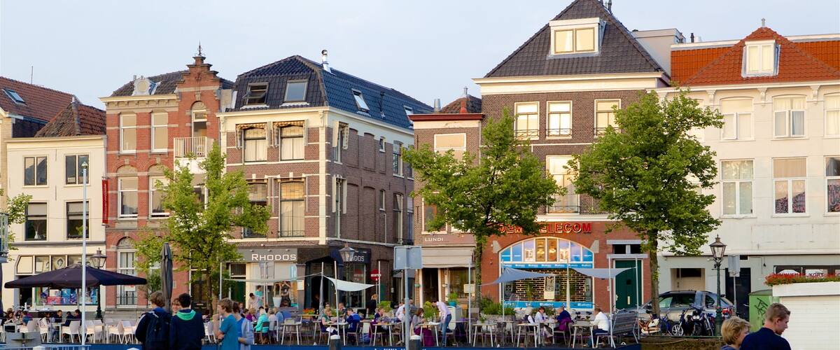 The Hague showing a river or creek as well as a small group of people