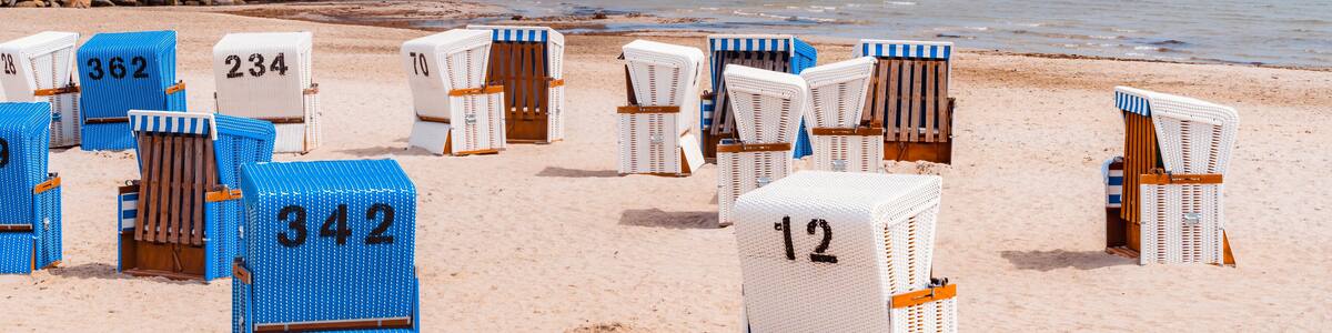 Wicker beach chairs at the beach with sunny weather