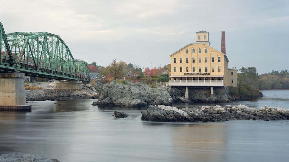 Sea Dog Brewing Company in Topsham, Maine seen from the shore of the Androscoggin River in Brunswick, Maine.
