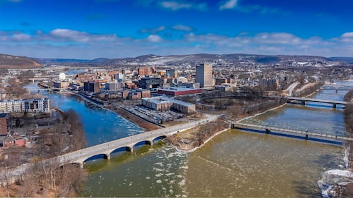 A cityscape with a river, bridges, and a snow-covered landscape.