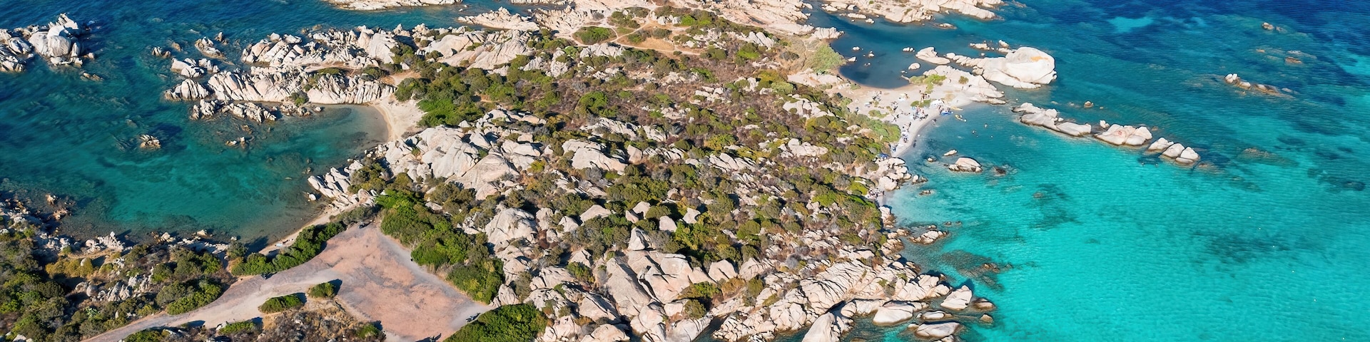Aerial view of Capocchia d'u purpu beach (Testa del Polpo) and its iconic granite rock on Giardinelli island in La Maddalena archipelago, Sardinia, Italy