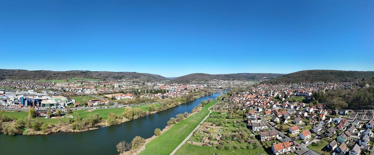 A river flowing through a town with residential areas and industrial buildings.
