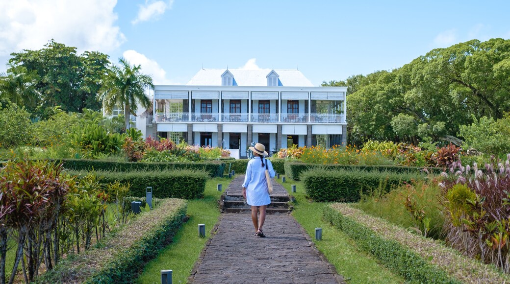 Le Chateau de Bel Ombre Mauritius, an old castle in a tropical garden in Mauritius.woman walking in a garden of an old castle