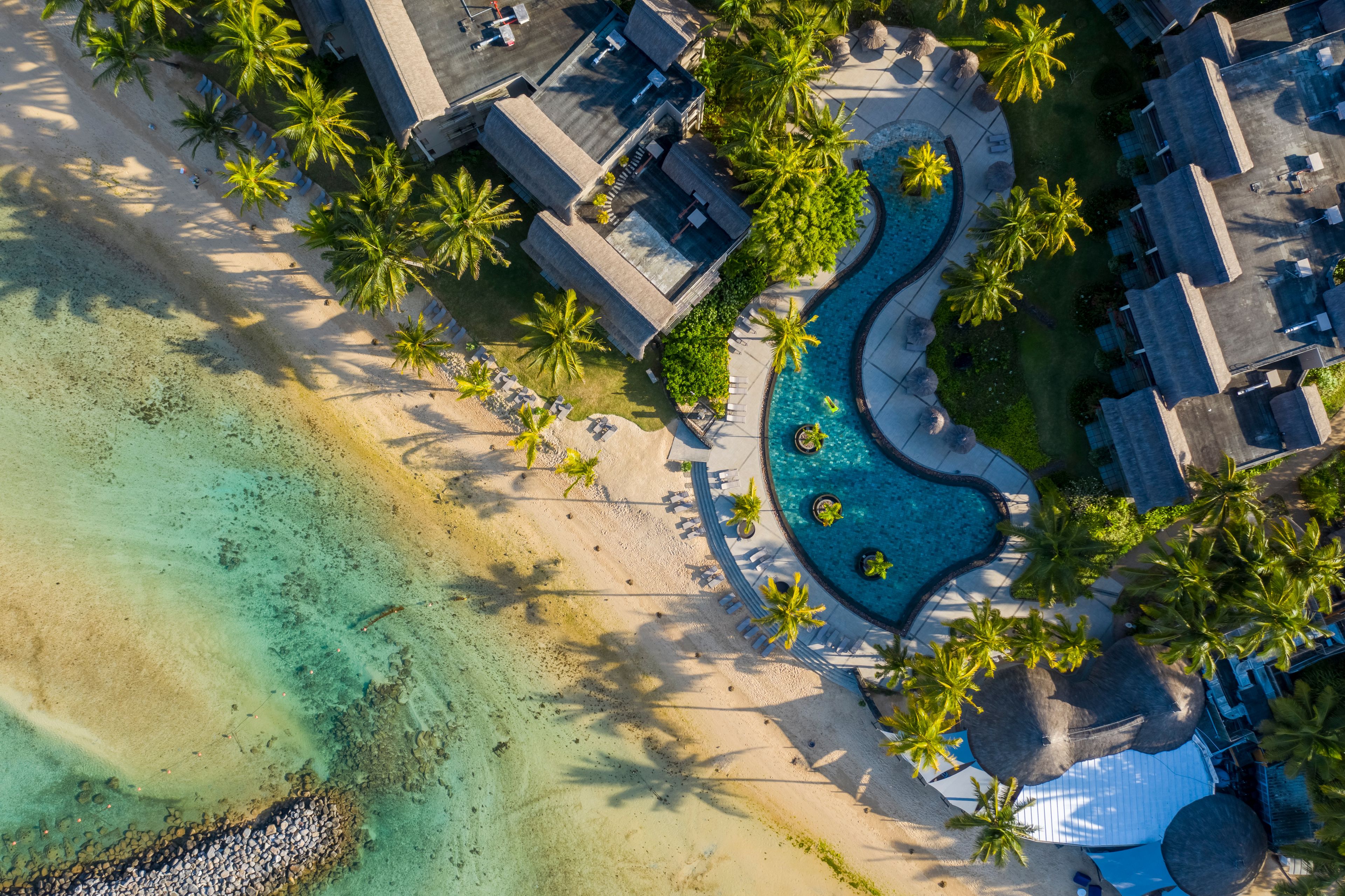 Aerial view of a swimming pool along the coast near the beach in a luxury hotel, Bel Ombre, Mauritius.
