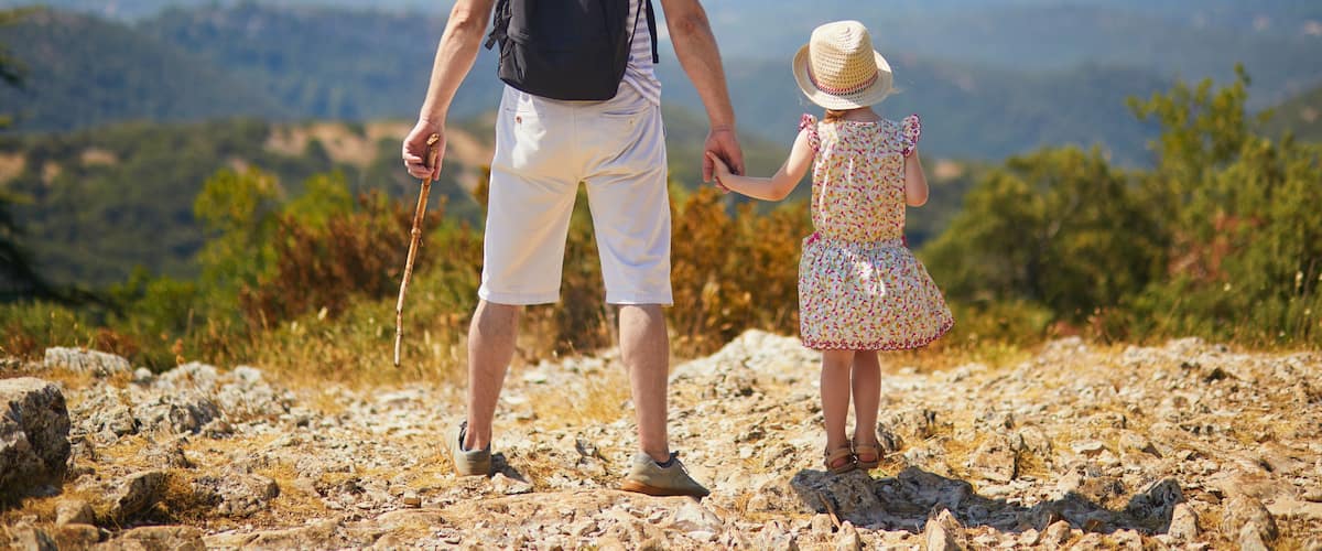 Father and daughter enjoying beautiful view from the top of the hill in Provence, Southern France