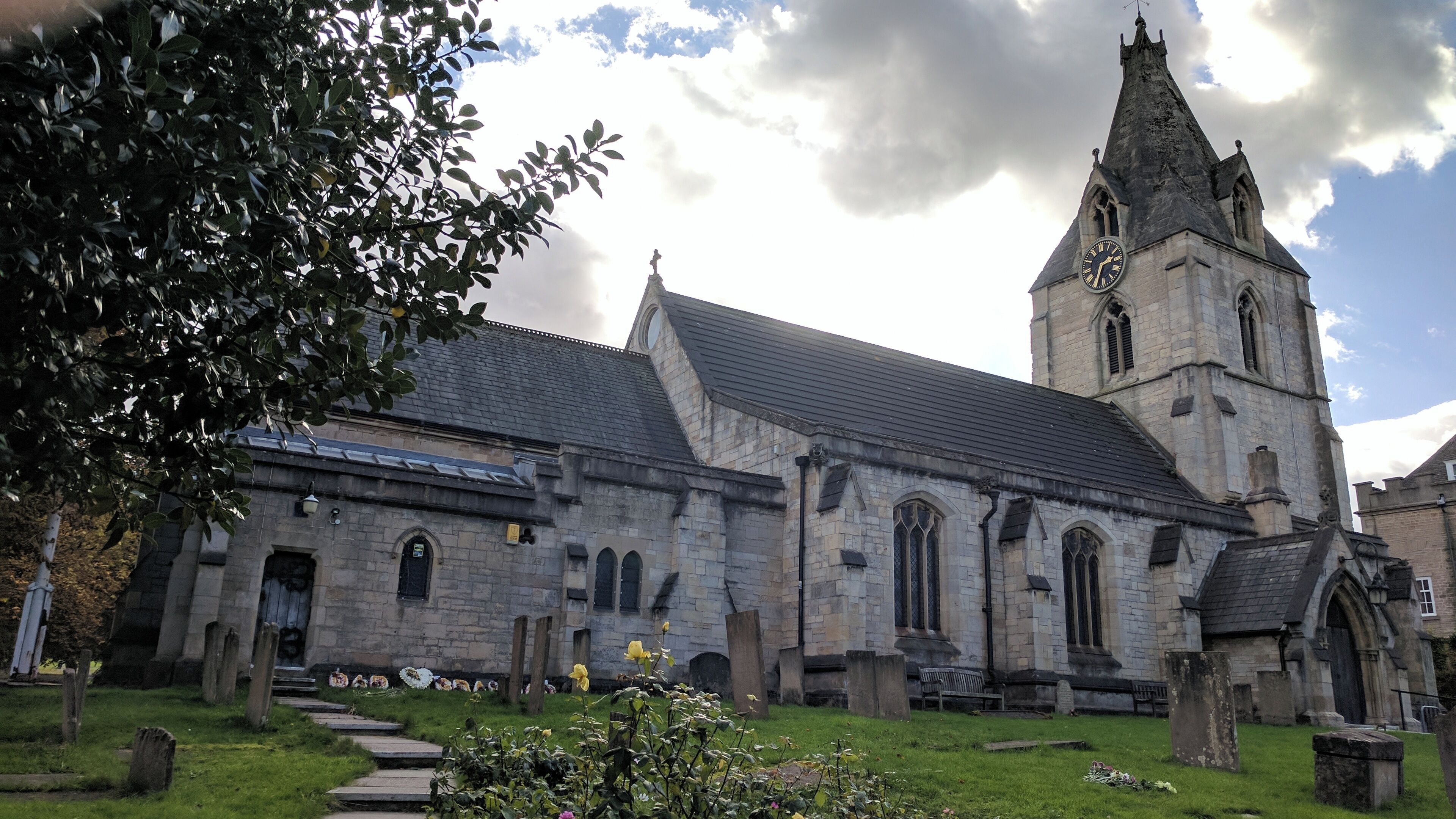 A historic church with a tall tower and a clock.