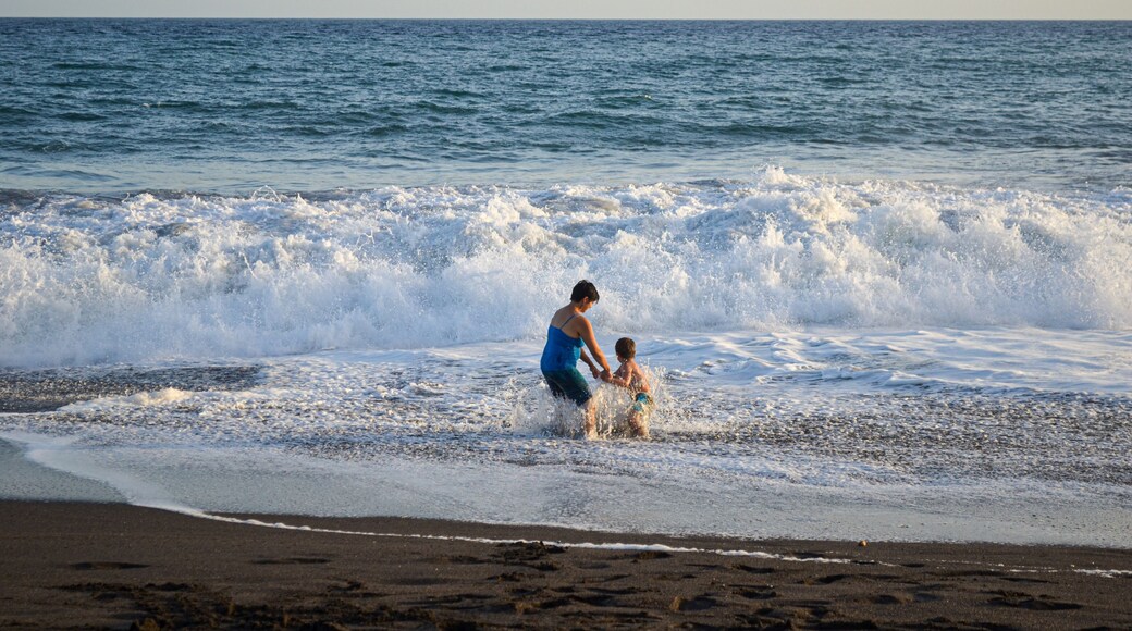 Mother and son playing in the beach.
