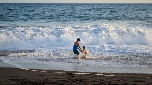 Mother and son playing in the beach.