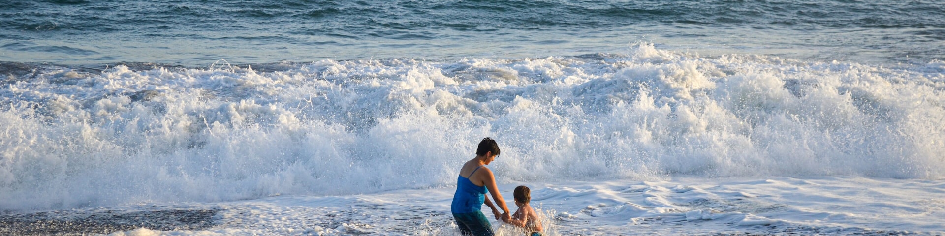Mother and son playing in the beach.