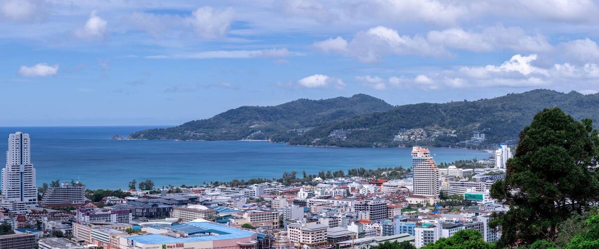 view of Patong and patong beach with the buildings and high-rise hotels and resorts in the background Kathu phuket Thailand