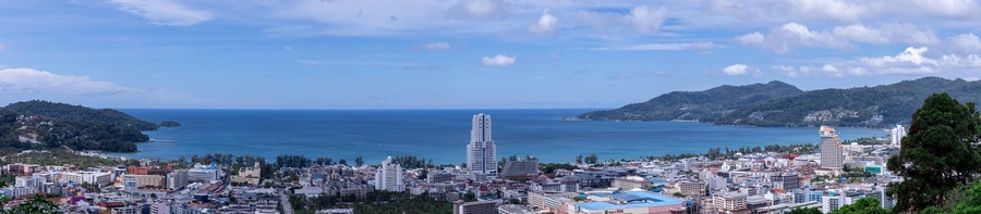 view of Patong and patong beach with the buildings and high-rise hotels and resorts in the background Kathu phuket Thailand