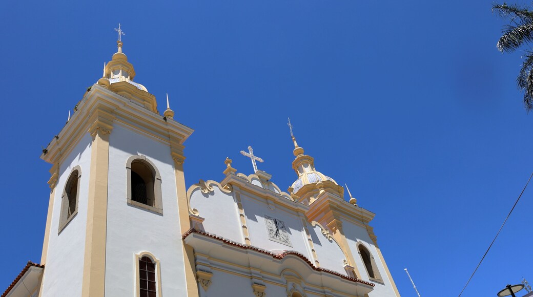 A white church with gold accents and a cross on top.