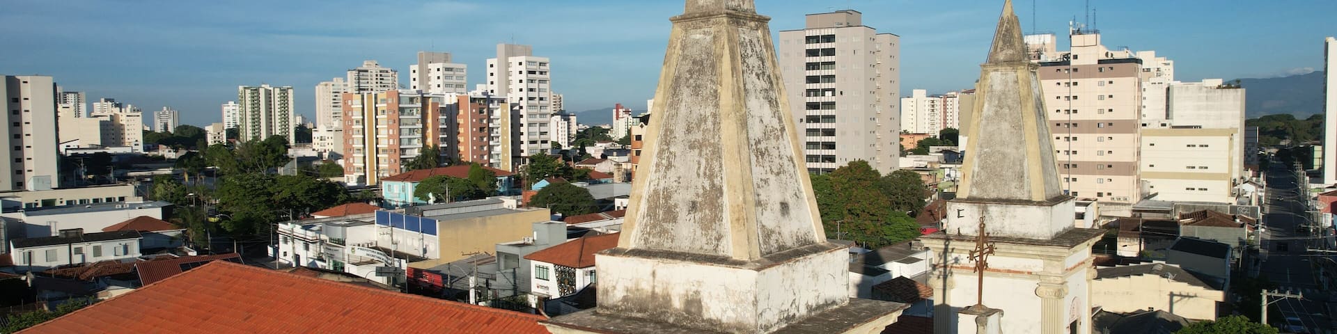 Aerial view of Nossa Senhora do Rosario Church in Taubate, Brazil, 18th century historic colonial church under sunny blue sky