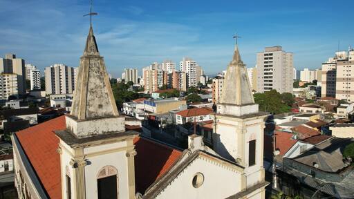 Aerial view of Nossa Senhora do Rosario Church in Taubate, Brazil, 18th century historic colonial church under sunny blue sky