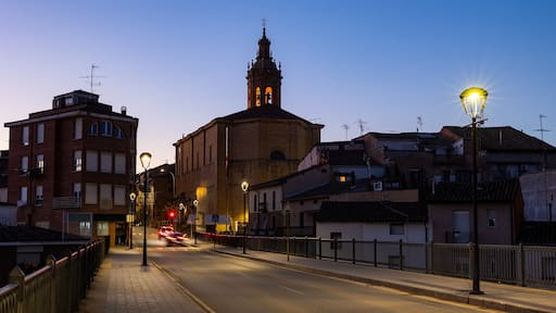 Deserted streets of ancient city Cenicero in province of Rioja, northeastern Spain. Soft evening light of lanterns illuminates narrow stone bridges of town Cenicero