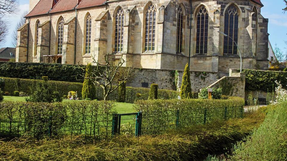 A historic church with a red-tiled roof and stone architecture.