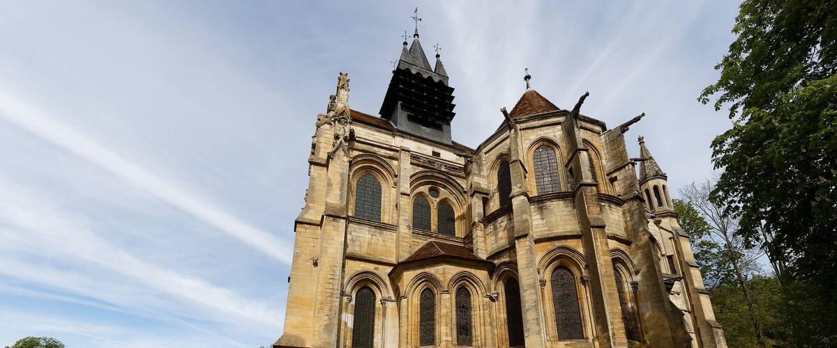 A historic cathedral with a prominent tower and arched windows.