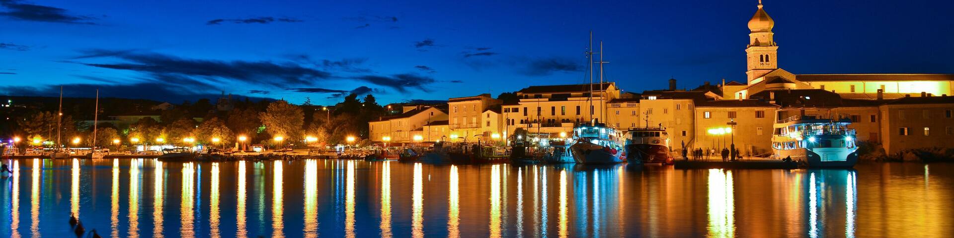 This is a view of Krk city coast at night. September 3, 2017. Krk, Croatia.; Shutterstock ID 718705408; purchase_order: SP-1332 HA Batch 2 August 2018; Order: ; client: HomeAway; other: To be paid wit