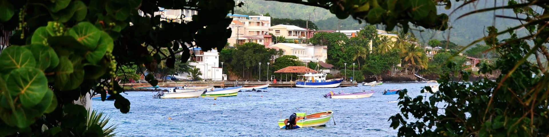 Scene of Sainte-Luce harbor in Caribbean island of Martinique, just before sunset. Fishing boats in harbor
