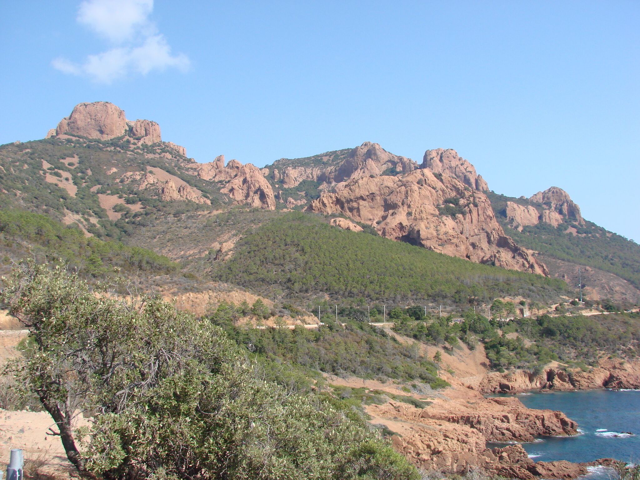 A rugged mountain range with rocky outcrops and sparse vegetation.