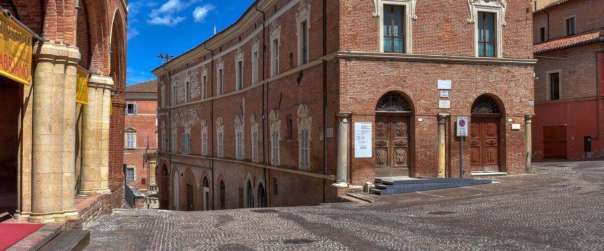 A historic building with arched windows and a red brick facade.