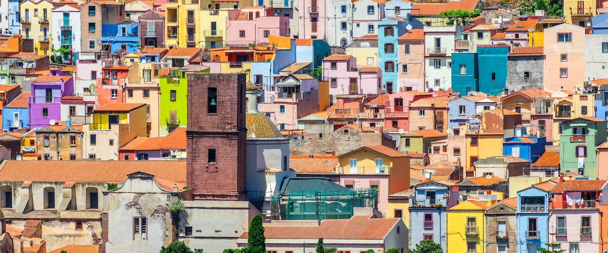 A densely packed urban area with colorful buildings and a prominent church with a bell tower.
