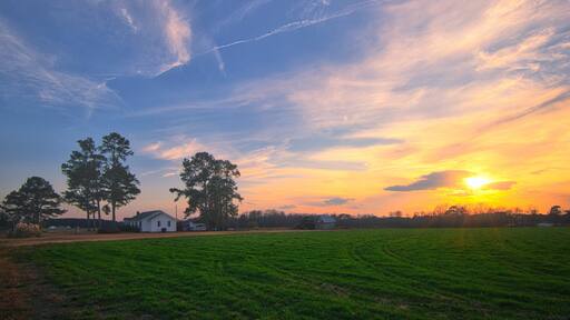 A nice sunrise over the field on a farmhouse in Lillington, North Carolina in vibrant colors