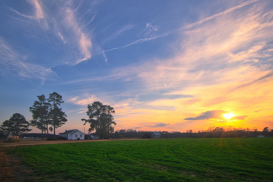 A nice sunrise over the field on a farmhouse in Lillington, North Carolina in vibrant colors