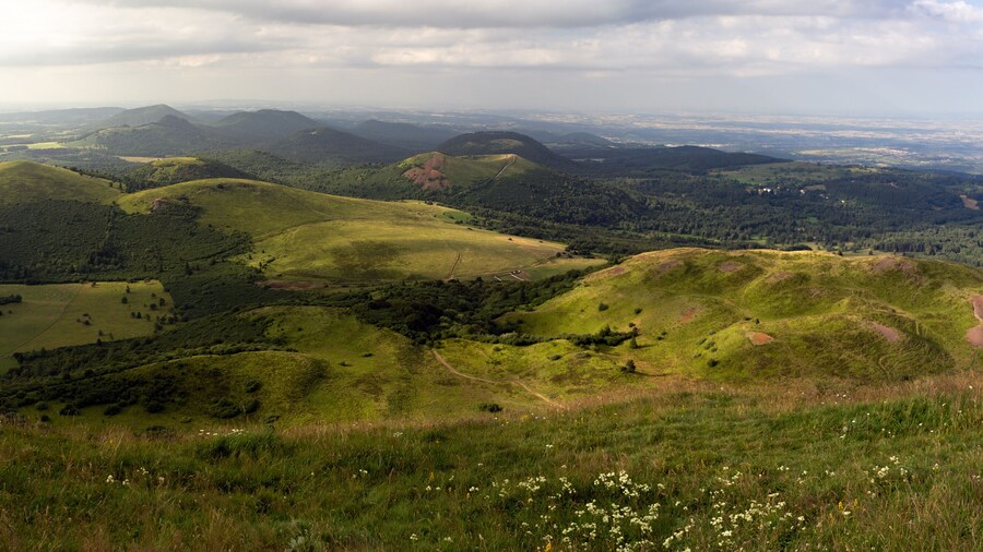 Auvergne vulcan since top of the Puy de Dome vulcan at sunset. Dramatic light landscape. Clermont Ferrand, France.