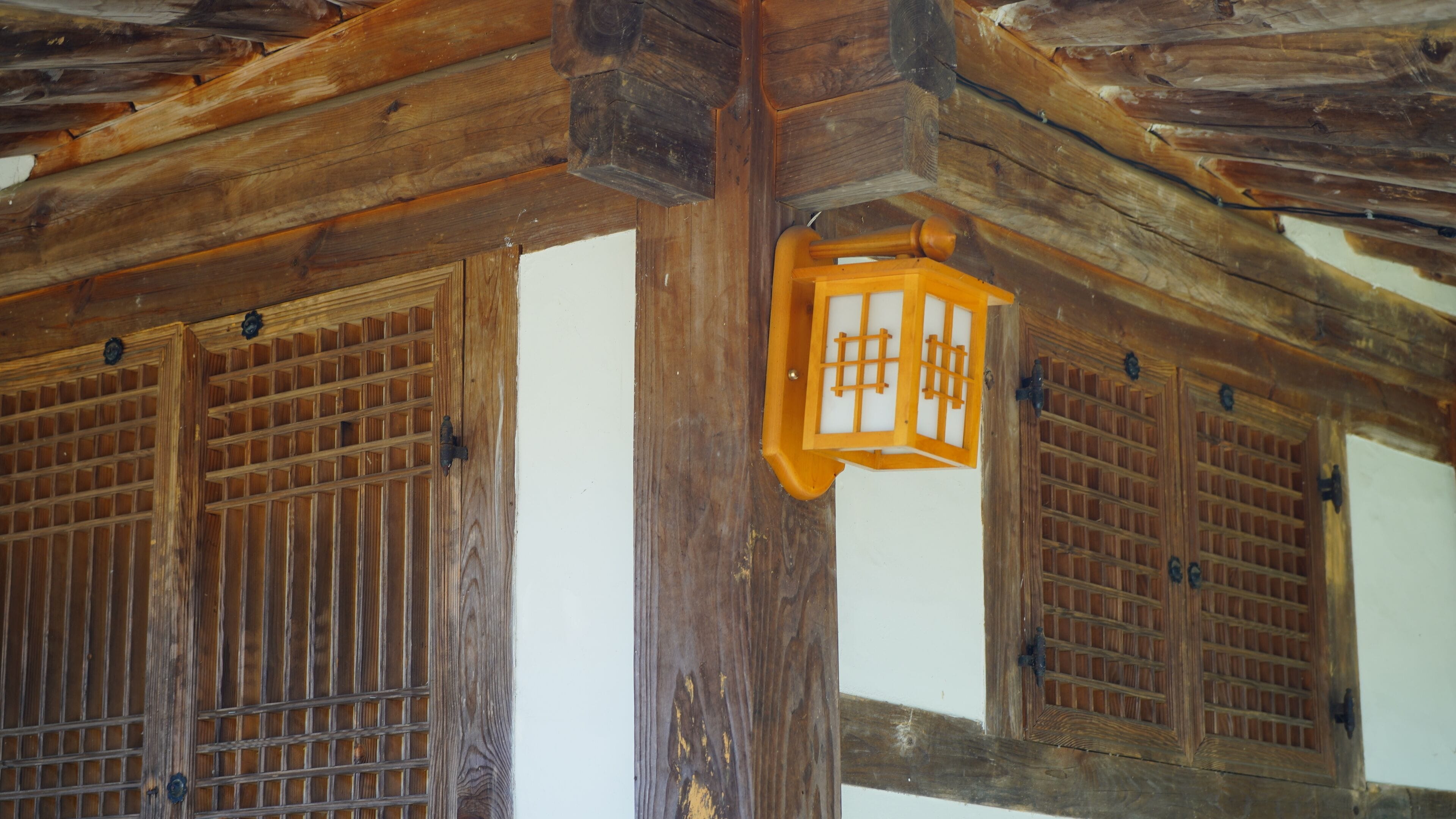 A traditional wooden structure with a lantern hanging from the ceiling.
