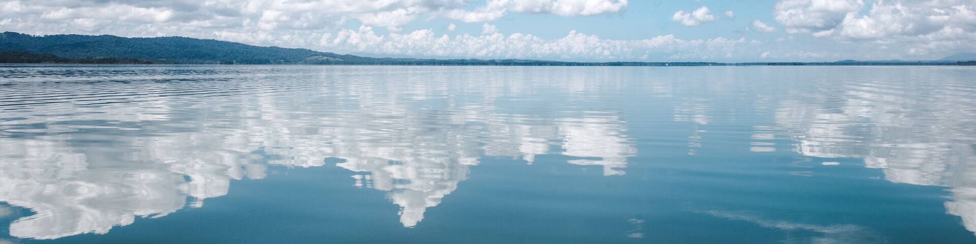 Beautiful tranquility of the calm, smooth water on the lake at El Golfete, in between Rio Dulce and Livingston in Guatemala