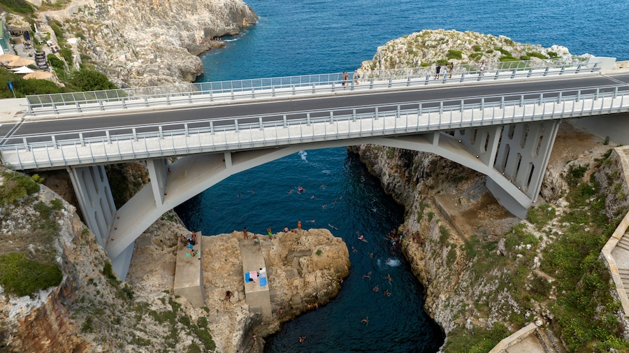 Aerial view of Ciolo's Bridge in the province of Lecce, Salento, Puglia, Italy. It is a single-span bridge and crosses a inlet. It overlooks the Mediterranean Sea.