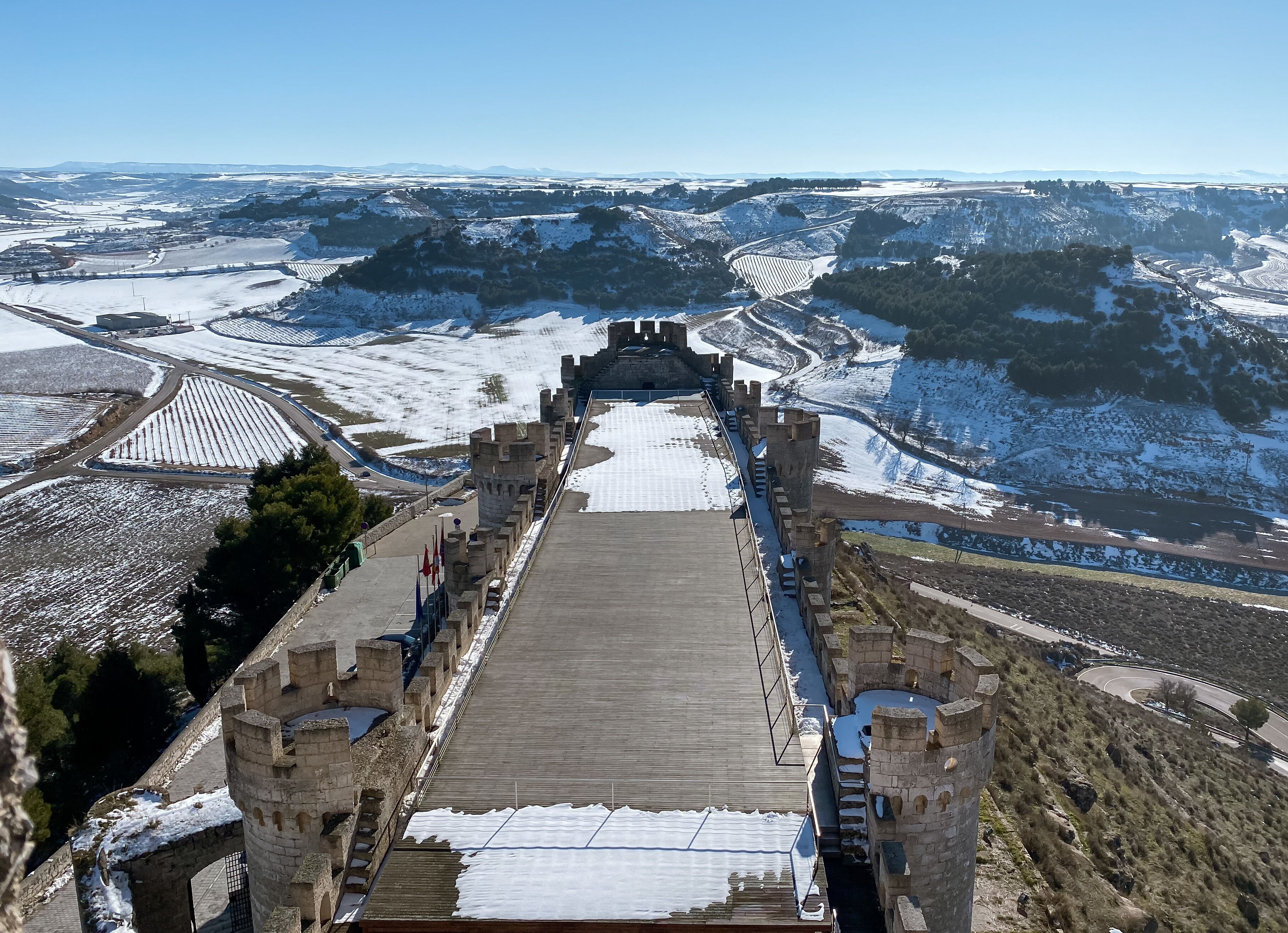 Penafiel Castle overlooking snowy fields on background of the blue sky