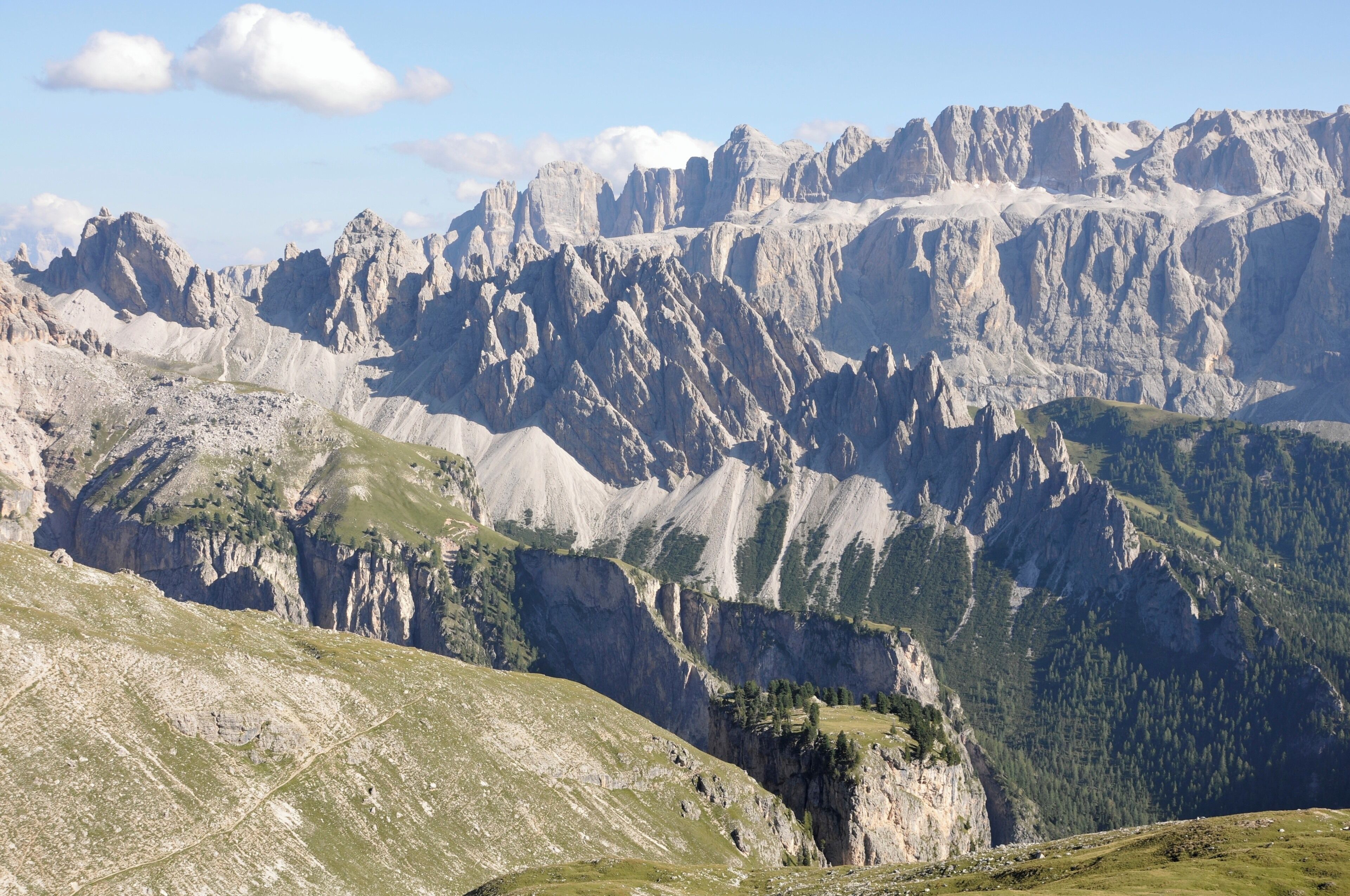 A mountainous landscape with rugged peaks and green valleys.