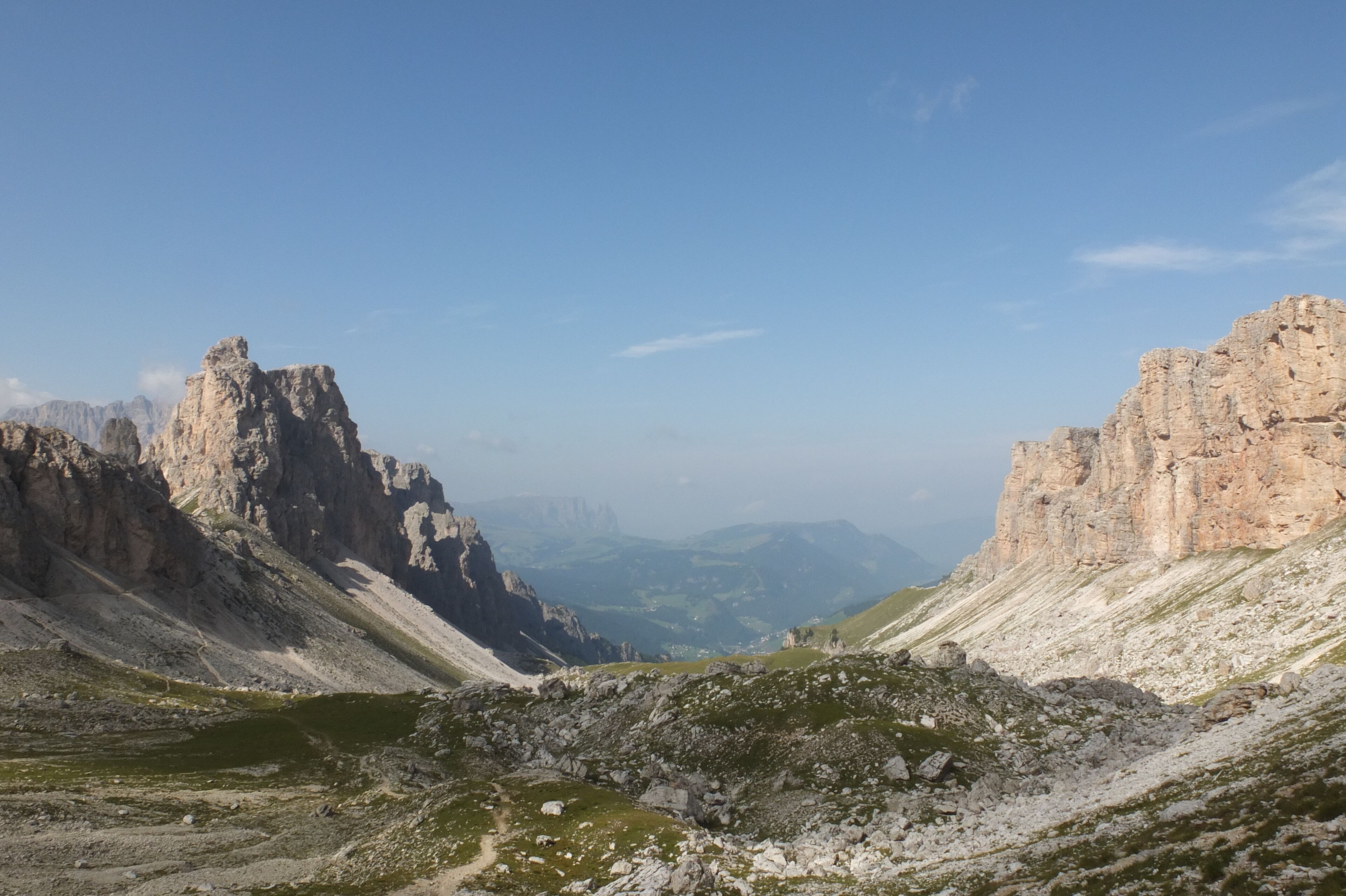 A mountainous landscape with rocky cliffs and a valley.