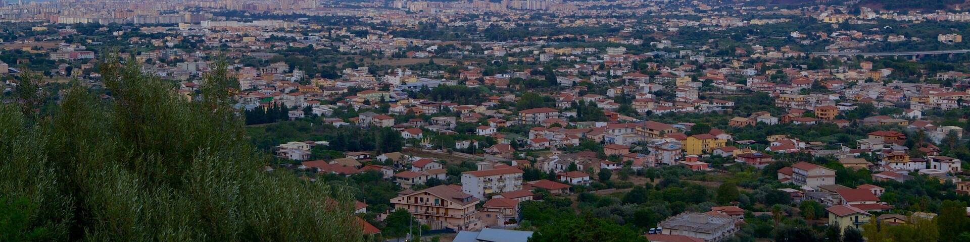 Monreale which includes a city and a sunset