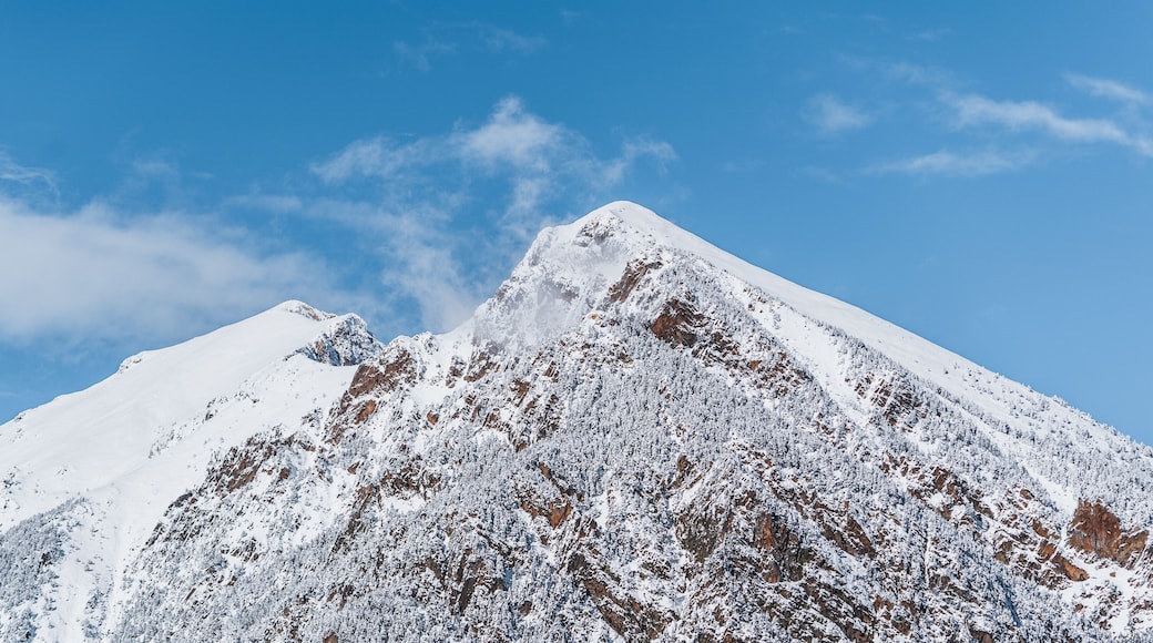 Panoramic view of snowy mountains. Abundance of snow that covers the entire mountain range. Sunny winter scenery. Tourism in Spain, Catalonia, Pyrenees, Ripollés, Vallter, Setcases, Gra de Fajol.