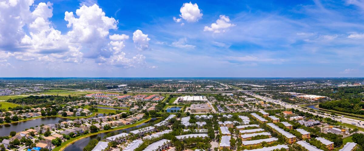 A residential area with a river, a highway, and scattered buildings.