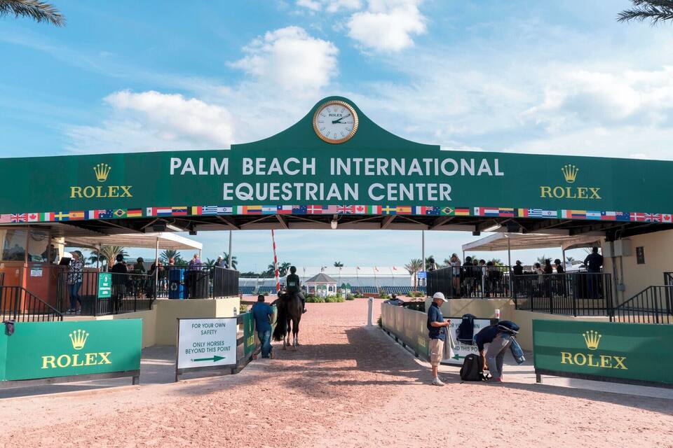 The Palm Beach International Equestrian Center entrance with flags and Rolex branding.