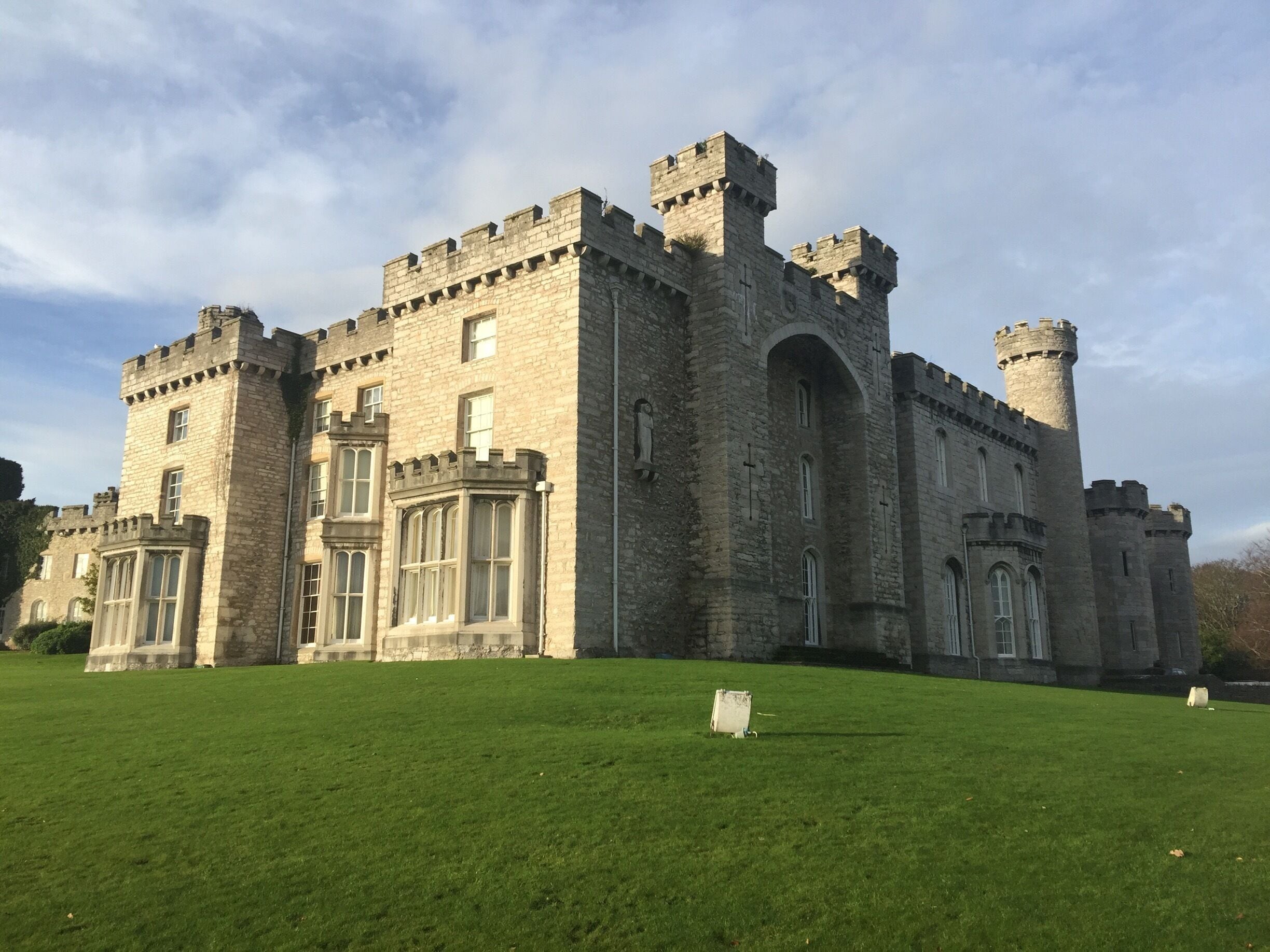 A large castle with multiple towers and arched windows.