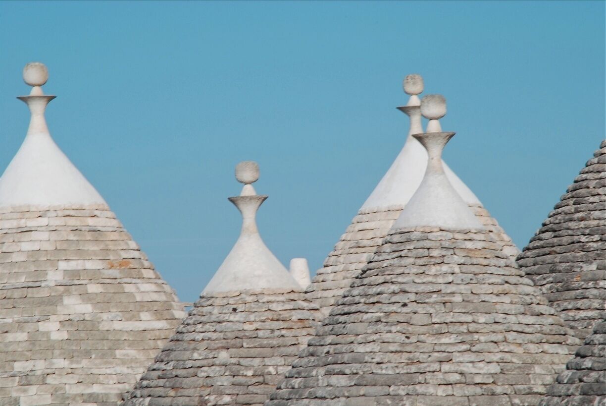 A row of conical roofs with decorative finials.