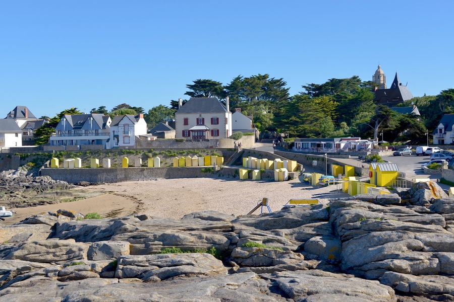 Beach of Saint Michel with its yellow beach huts of Batz-sur-Mer, a commune in the Loire-Atlantique department in western France. The town lies between the Bay of Biscay and its salt marshes.